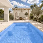 Cyprus Blue Shimmer fibreglass pool with Mediterranean-style landscaping and alfresco area in Perth